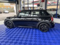 A black Mini Cooper with paintwork buffed and polished with a polymer coating.