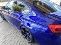 A blue BMW which has been highly polished and shows the metallic in the paint.