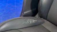Worn leather bolster; normal wear is accepted, but the standard is a judgement call rather than a measurement.