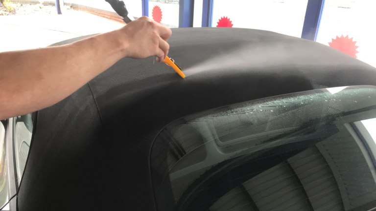 Using an air blade to dry a soft top.