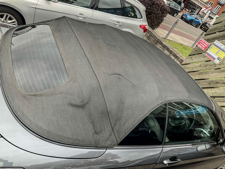 Wear marks on a soft top convertible roof before treatment.