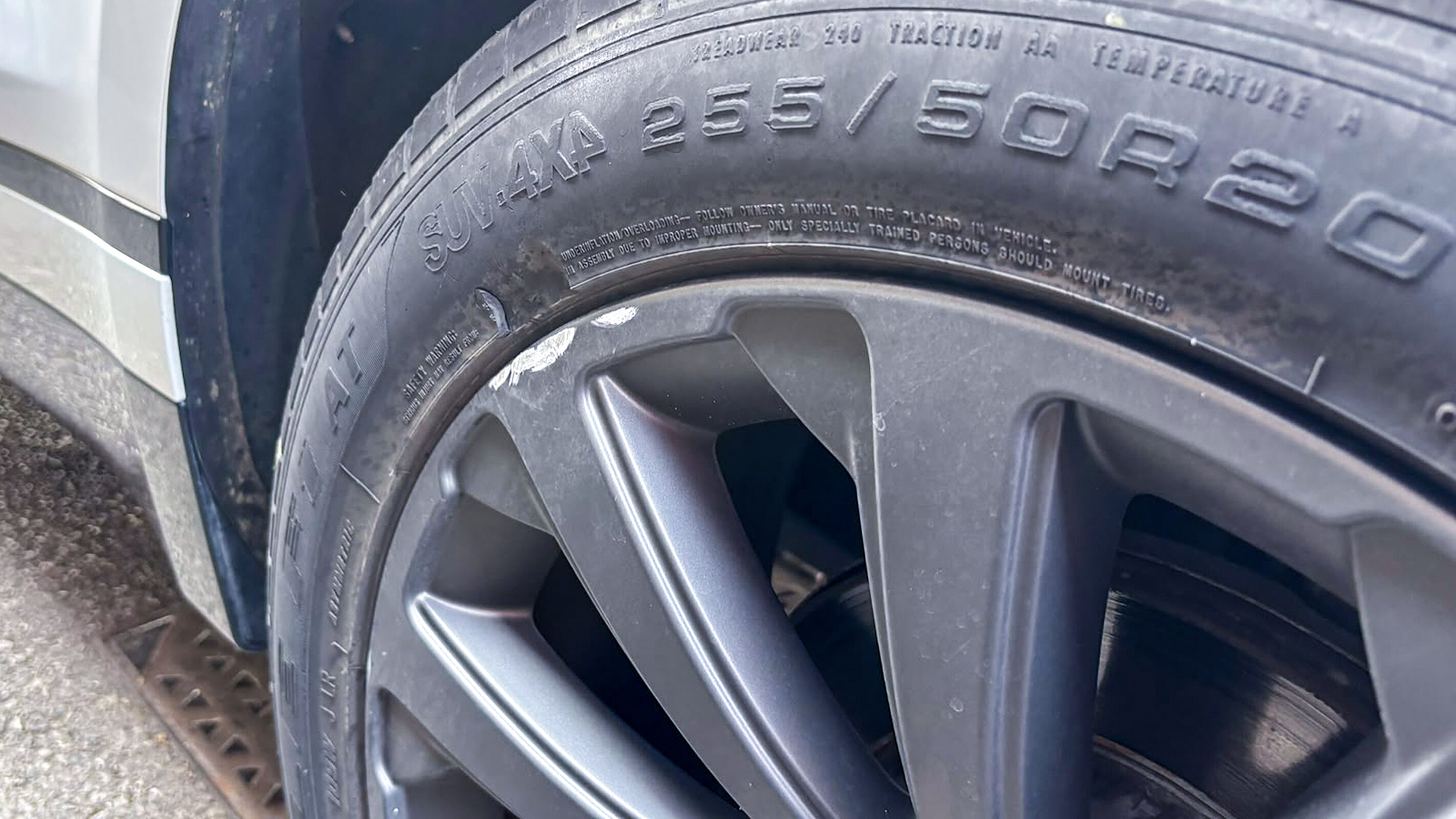 A kerbed alloy wheel; damage to the rim edge is judged more leniently than a mark on the spokes or fascia.