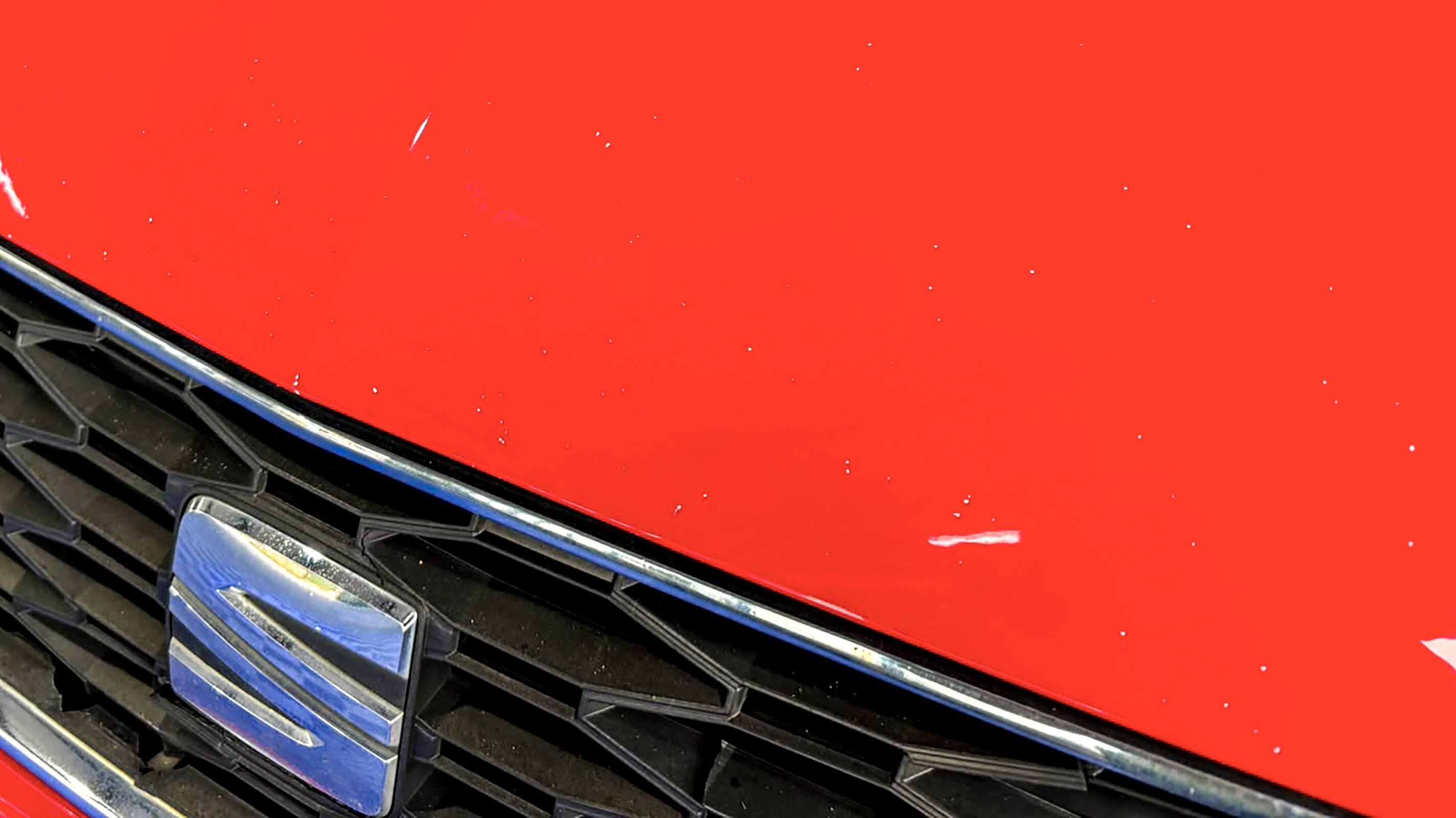 Stone chips along the bonnet leading edge, the kind ordinary driving collects over a lease term.