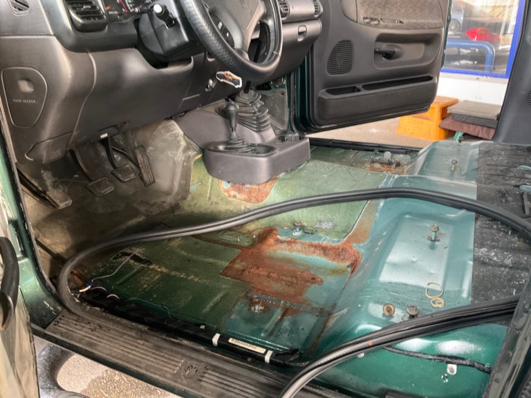 Rusty floor pan in Toyota Landcruiser. 
