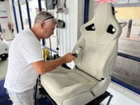Allan paints the leather seat upright.