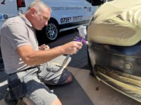 Craig from Spray-Pro repairing a bumper.