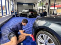 Alfie detailing the bumper on a newly polished car.
