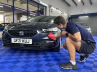 Alfie detailing a bumper to a high sheen.