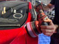 Buffing an older car to make the paintwork look like new.