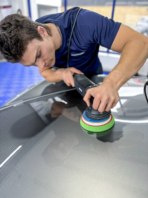 Alfie buffing a Porsche.
