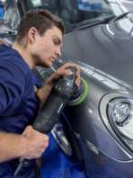 Alfie polishing a Porsche.