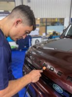 Detailing around the badge of a Range Rover, with our smallest polisher.